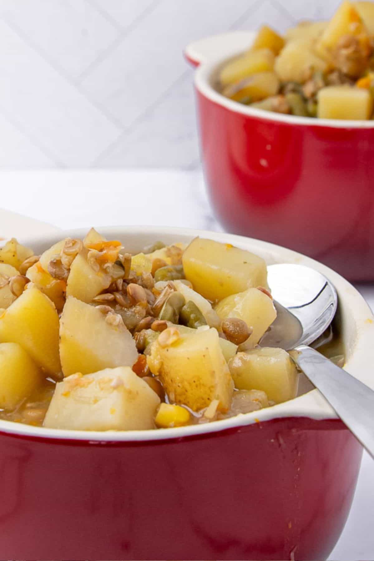 A closer view of the lentil stew served in red bowls.