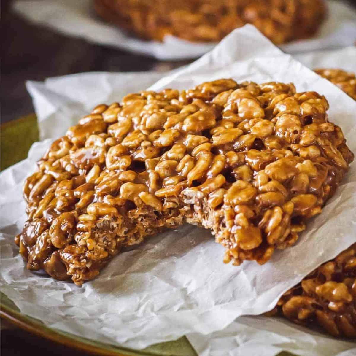 Homemade star crunch cookie on a piece of parchment paper with a bite taken out of it