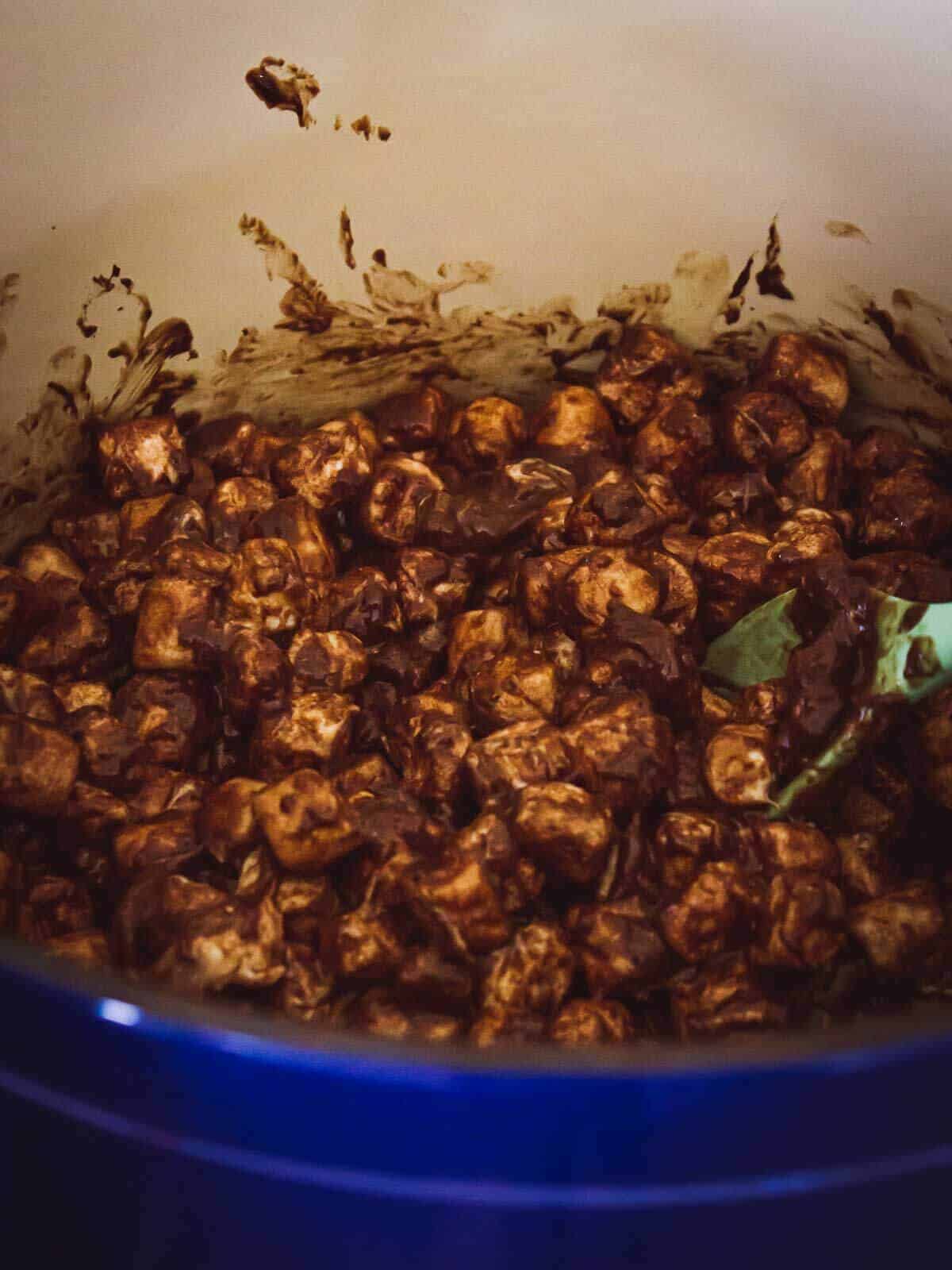 The mixture in the pot beginning to melt and blend together.