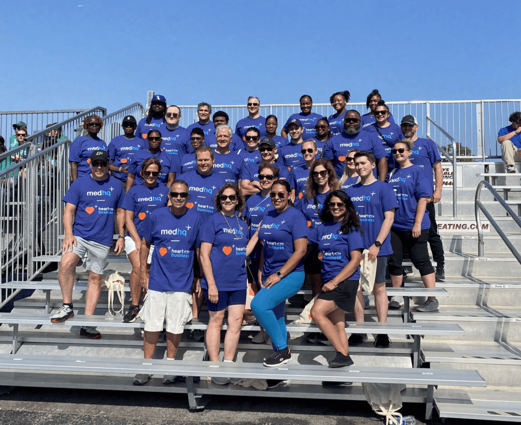 The MedHQ team posing on a set of bleachers