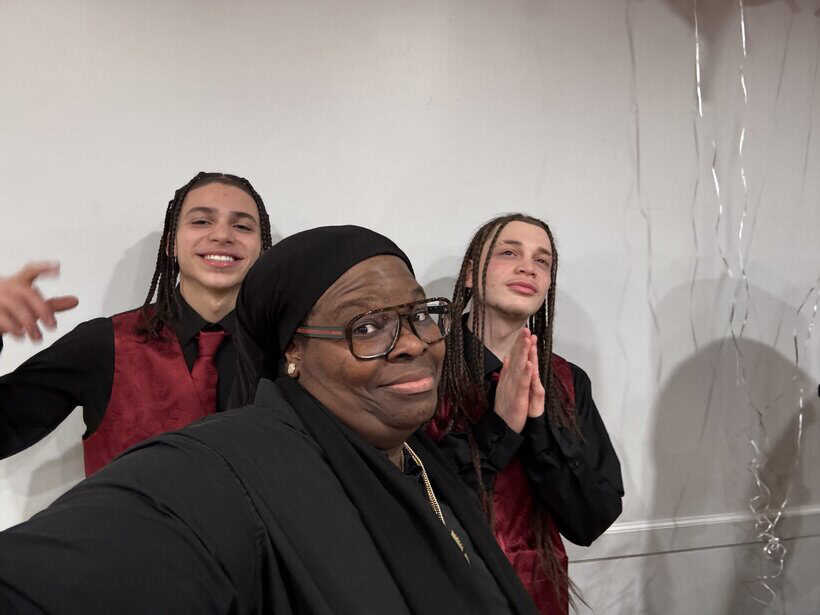 Friendly women celebrating at an indoor event, smiling and enjoying together.