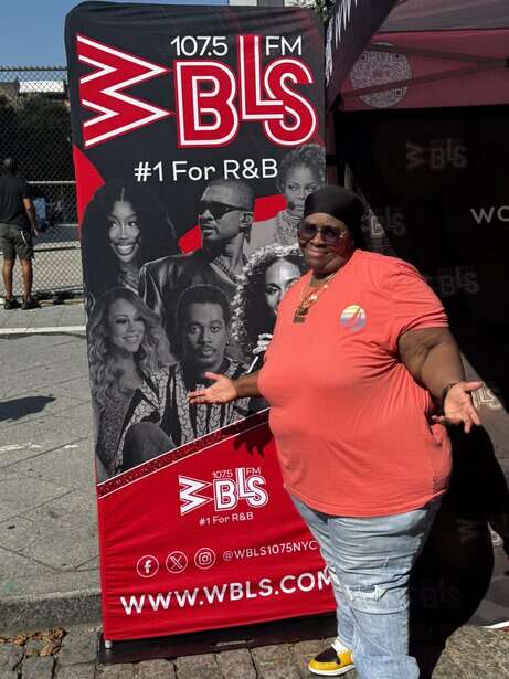 Radio personality at WBLS 107.5 FM event promoting R&B music in New York City.