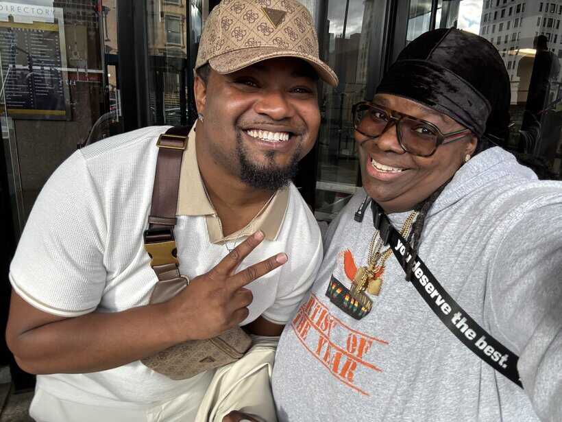 Smiling men taking a selfie outdoors, celebrating friendship and positive vibes.