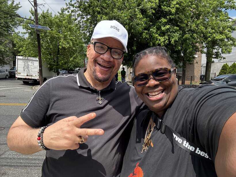 Smiling man and woman taking a selfie outdoors on a sunny day.