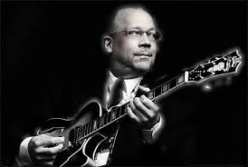 Guitarist playing jazz music in black and white.