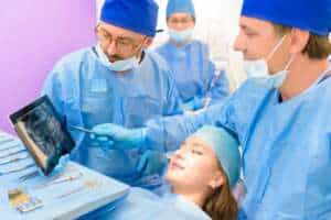 Dentists in Albania explaining bone grafting.