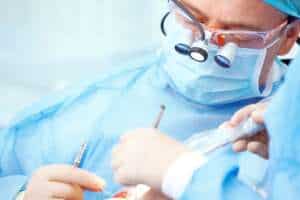 Dentist performing bone graft transplant in Albania.