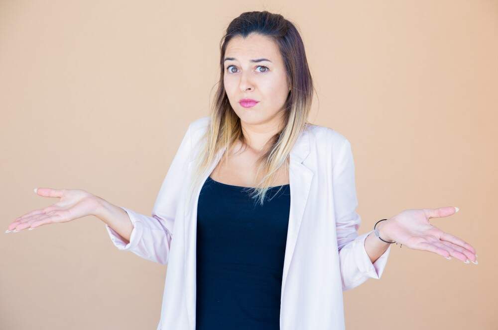 Woman confused about medical tourism options in Albania for aesthetic procedures.