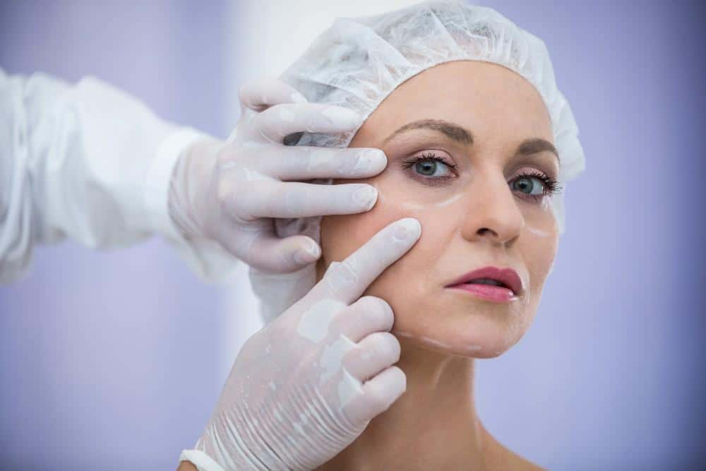 Woman receiving facelift procedure to reduce wrinkles in Albania.