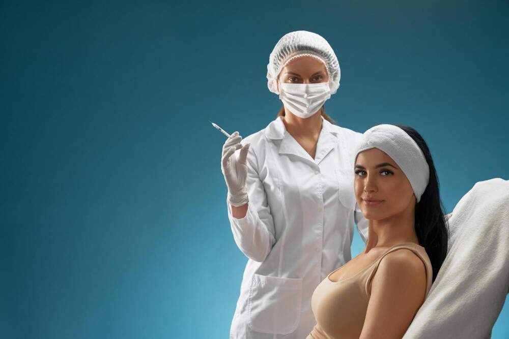 Woman receiving cosmetic consultation from a healthcare professional in a clinical setting.
