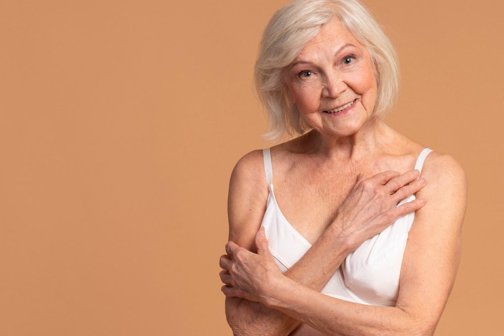 Elderly woman smiling, showing smooth skin after chemical peel treatment for wrinkles.