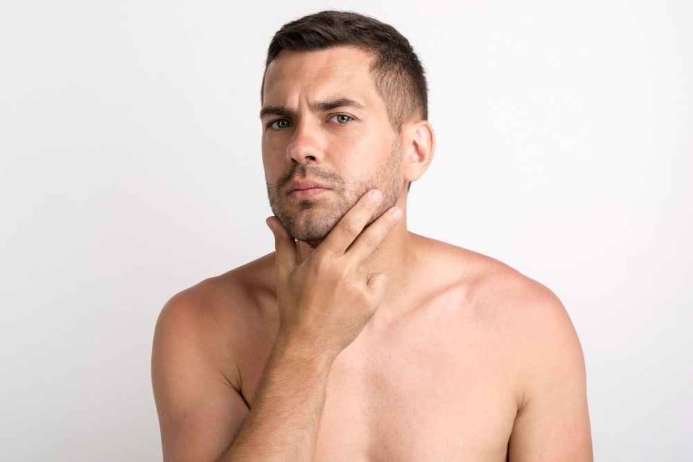 Confident man contemplating cosmetic surgery options for self-improvement.