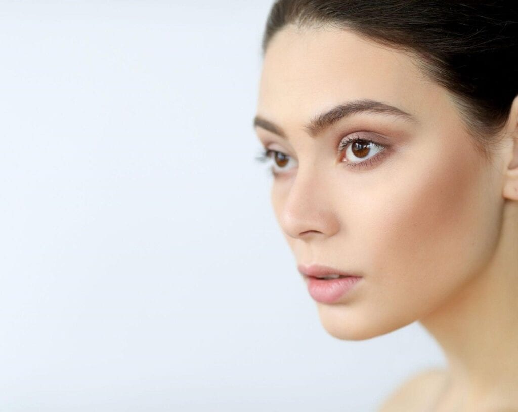 Woman with smooth, youthful skin after chemical peel treatment for crow's feet.