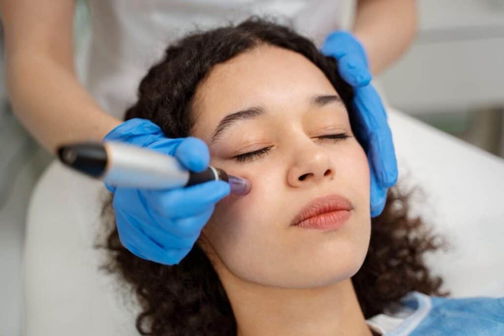 Woman receiving non-invasive anti-aging facial treatment in Albania.