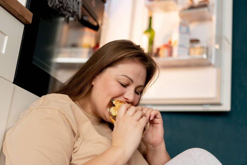 Woman enjoying a healthy snack at home, promoting weight loss and healthy lifestyle.