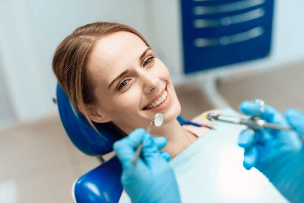 Woman receiving dental implant treatment at a clinic in Albania.