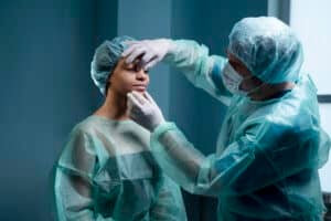 Surgeon performing rhinoplasty consultation in Albania clinic.