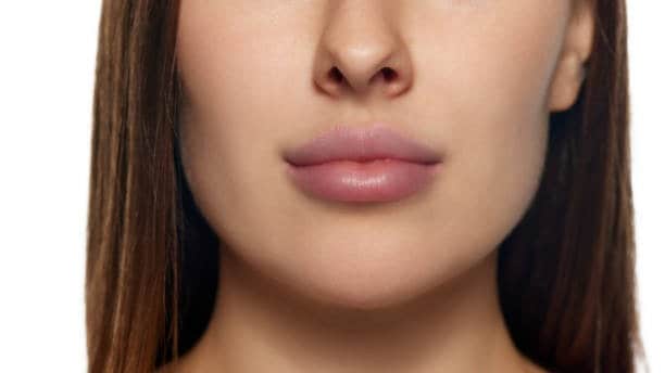 Close-up of a woman's lips and chin, highlighting cosmetic treatment options in Albania.