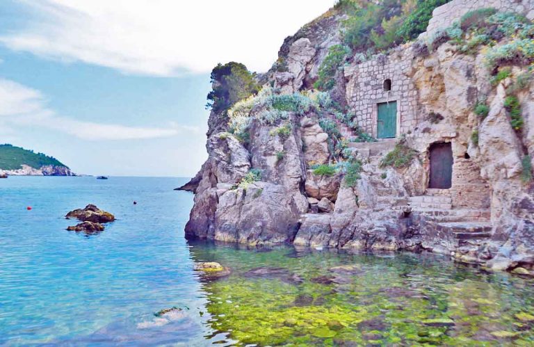 Little green door in the rocks outisde of Dubrovnik old town