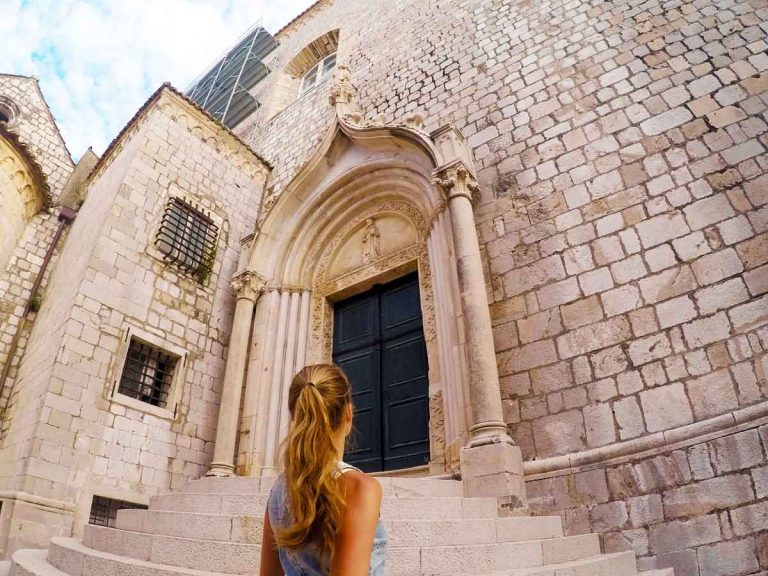 Beautiful carved doorway at the top of a short flight of stairs inside Dubrovnik Old Town
