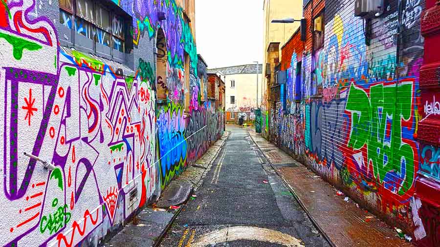 A street full of colorful arts and murals painted on the walls