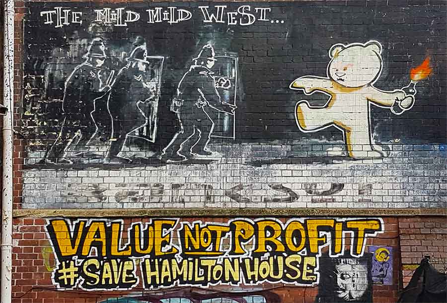 The Wild wild west is on a wall painted with murals outside of Hamilton House