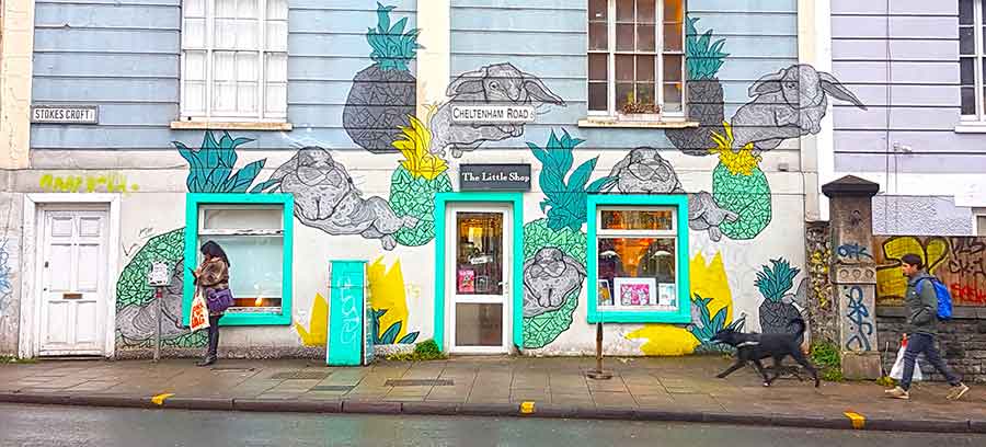 'The Little Shop' on the junction where Stokes Croft and Cheltenham Road meet with people passing by