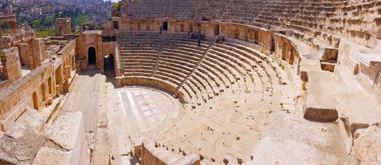 North Theatre in Jerash, Jordan - an open theatre in a semi-circular shape with a front wall featuring a sandstone staircase