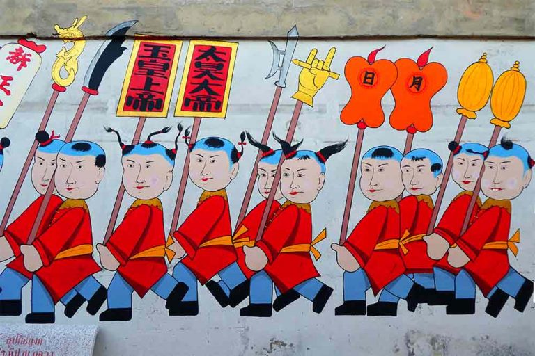 A section from a l-o-n-g mural of a traditionally clad troupe of soldiers found along the wall at the entrance to the Chinese shrine