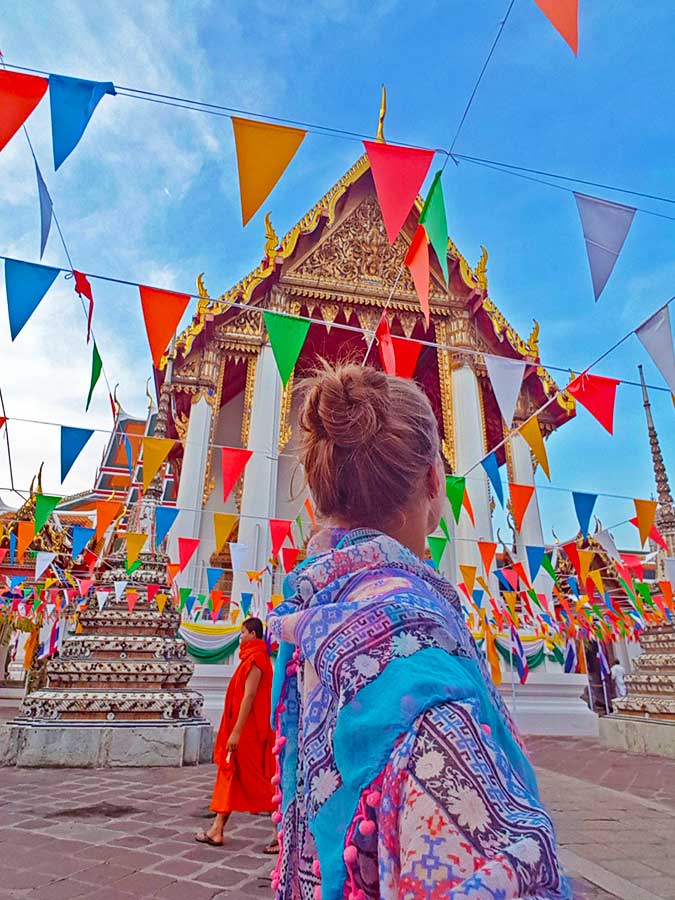 Best Bangkok Itinerary: 4 Days Guide to Thailand's Capital 8 The back of my head looking at the Colourful flags decorating Wat Pho