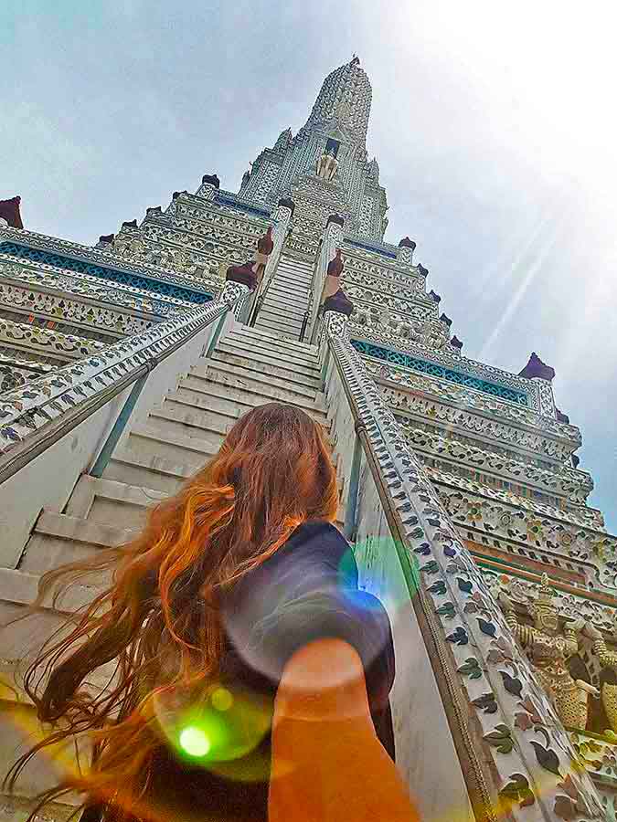 Best Bangkok Itinerary: 4 Days Guide to Thailand's Capital 12 Me loking up at The giant central prang at Wat Arun
