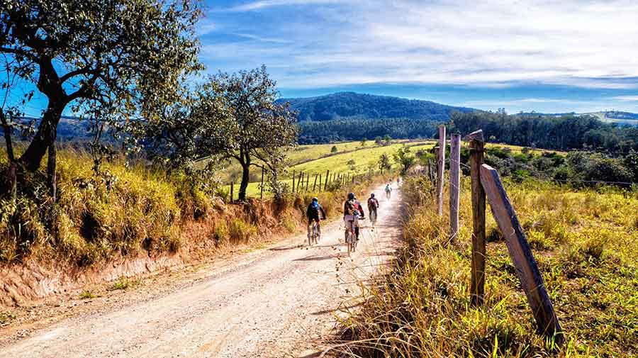 Extreme Adventures in Europe: 29 Best Adventure Sports in Europe 8 A group of people is mountain biking around Sicily on a sunny day, relishing the beautiful scenery and weather.