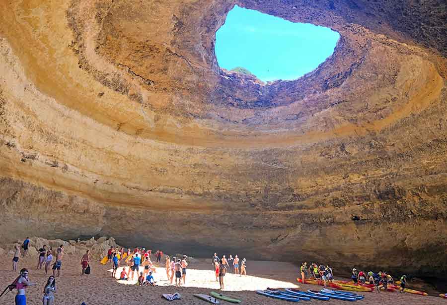 33 Best Hidden Coves and Secluded Beaches Around the World 26 The Benagil Caves in Portugal reveal a hidden treasure: a small beach tucked inside a cave; remarkable cave showcases a hole at its center, allowing sunlight to stream through and illuminate the secluded beach within.