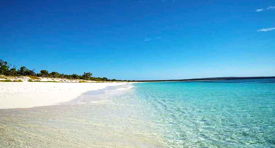 33 Best Hidden Coves and Secluded Beaches Around the World 13 Bahia de las Aguilas in Dominican Republic featuring its clear, blue water meets the white sand on a shoreline