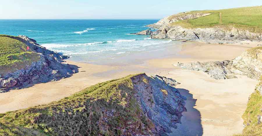33 Best Hidden Coves and Secluded Beaches Around the World 24 Porth Joke Cove in Cornwall, UK, offers a picturesque view: the blue waves of the ocean gently meet the brown sands at the shoreline on a sunny day