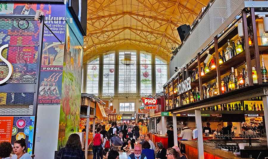 Best Riga 3 Days Itinerary: Exploring ‘Paris of the North’ 24 Inside Riga Central Market. Stalls selling food and local produce with lots of people.