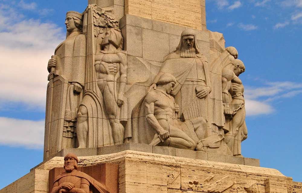 Best Riga 3 Days Itinerary: Exploring ‘Paris of the North’ 25 The freedom monument in Riga with carvings of people.