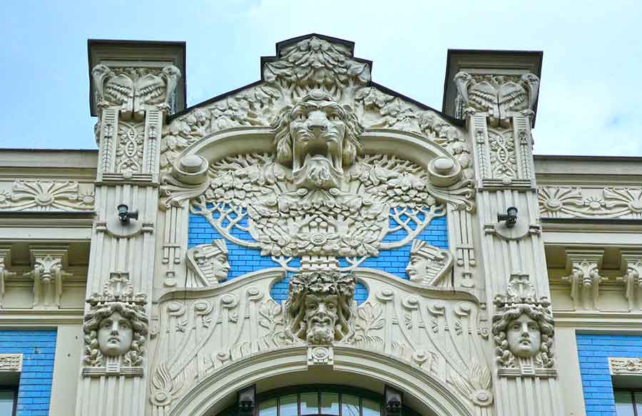 Where to See Art Nouveau in Riga, Latvia: Exploring The Art Nouveau District, Riga 9 Apartment building, Alberta Street 8 in Latvia showcases its head faces carvings and detailed carvings on the wall of the building
