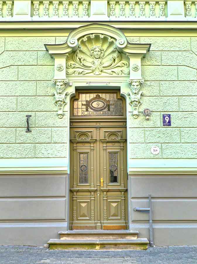 Where to See Art Nouveau in Riga, Latvia: Exploring The Art Nouveau District, Riga 15 A carved art on the top of the rust-gold colorway door at the apartment building, Alberta Street 9
