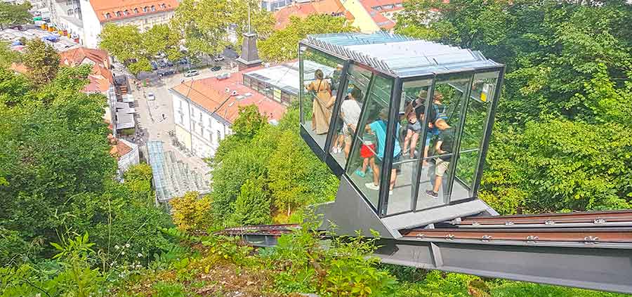 Tourist on board in Funicular Railway to Ljubljana Castle offering a city view from above