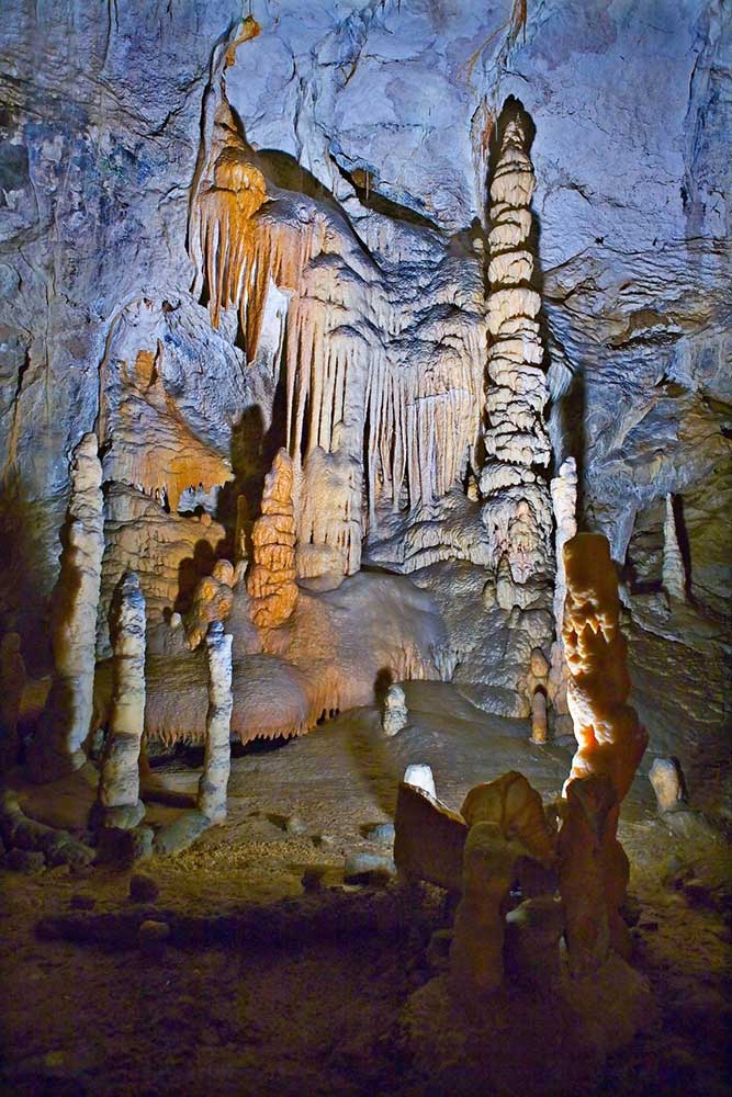 Postojna Cave System, Slovenia, an extensive underground world featuring natural rock formation with a play of light and shadows on the cave