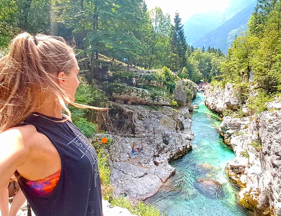 A woman taking a selfie admiring the Soca river in Slovenia
