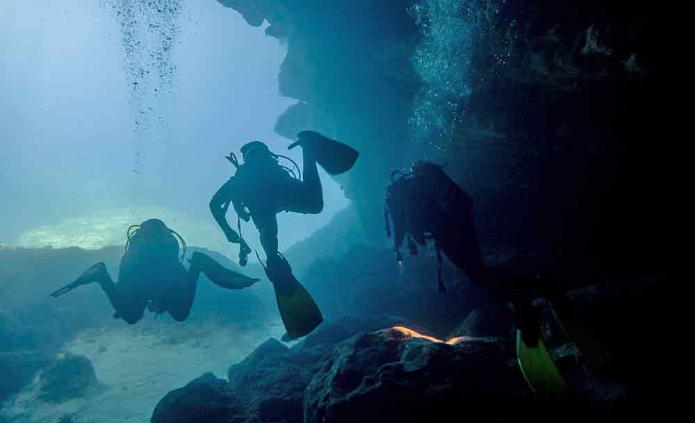 Extreme Adventures in Europe: 29 Best Adventure Sports in Europe 9 Three divers tried the cave Diving in Gozo Malta