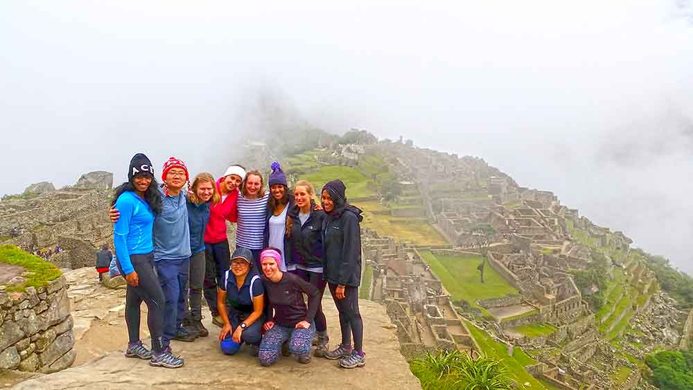 G Adventures Inca Trail Review: What to Expect on The Inca Trail Trek to Machu Picchu 20 Our group at Machu Picchu we arrived and it was cloudy, so you can only see a few of the ruins of the background, the rest is white cloud.