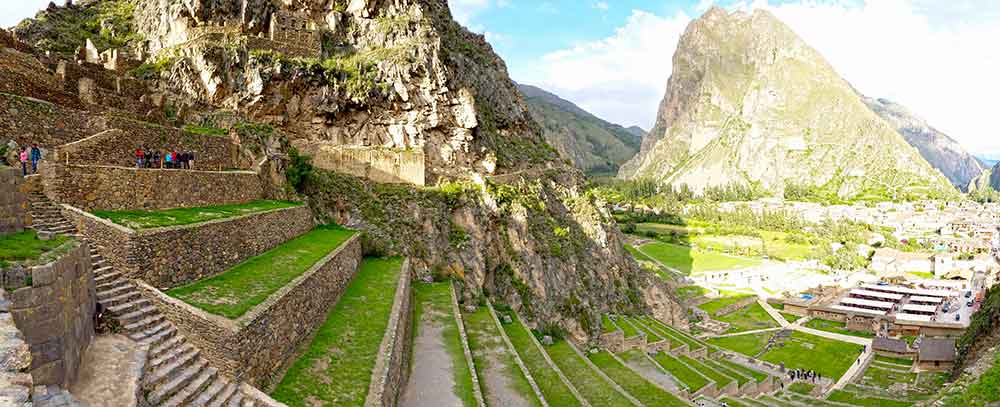 G Adventures Inca Trail Review: What to Expect on The Inca Trail Trek to Machu Picchu 14 The ruins of Ollyantaytambo showing the grassy terraces against the mountainside with the town in the background.