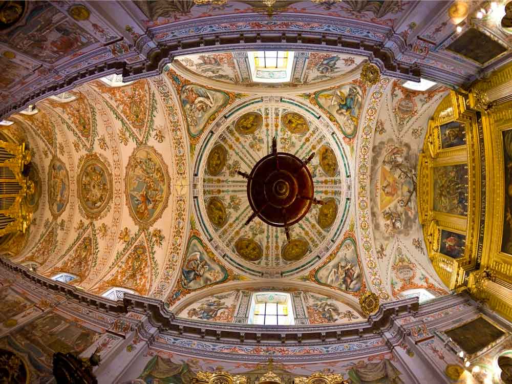 A decorative domed ceiling of a church