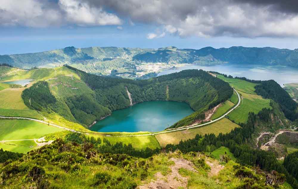 The Azores in Portugal features a lake surrounded by lush green land and trees.