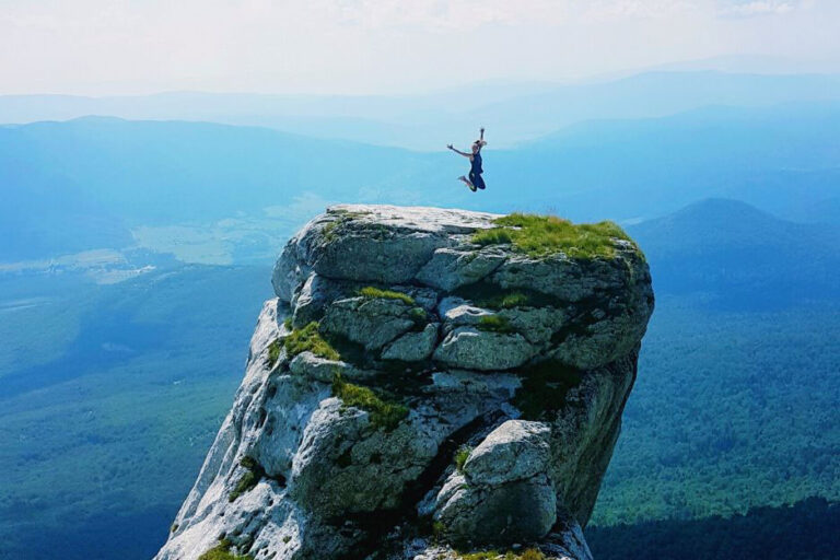 Me jumping on top of a giant rock formation at the top of the Pljsevica Hike in Croatia.