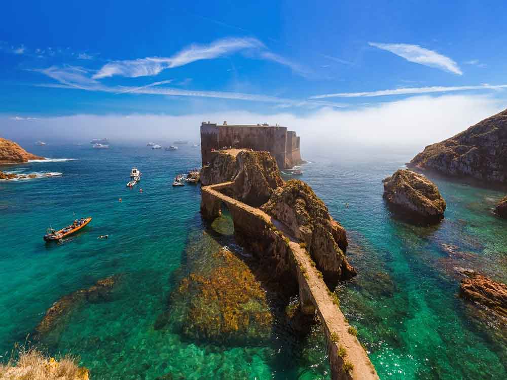 Fort of San Joao Baptisa in Berlengas Islands featuring a rocky small pathway going to fortress surrounded by turquoise clear water