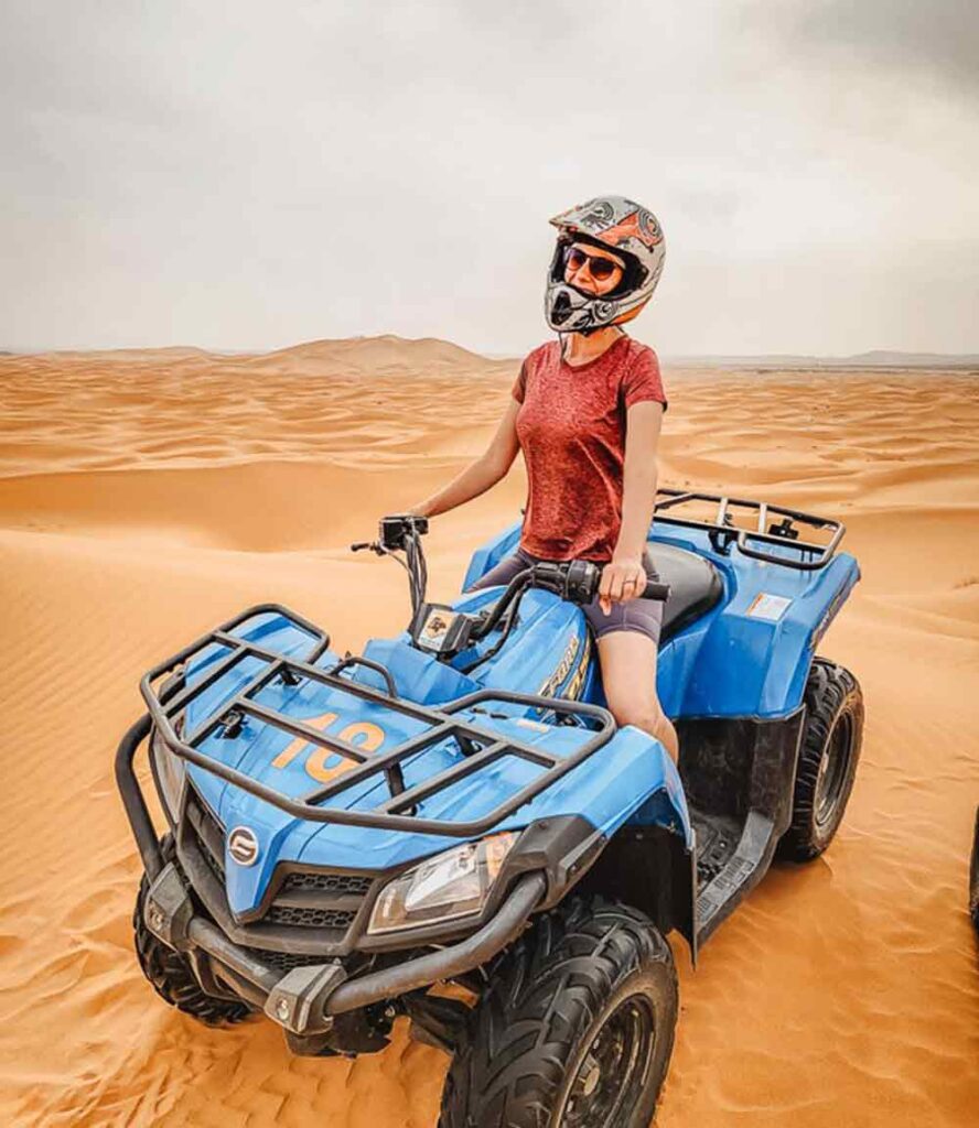 Woman riding a quadbike in the desert.